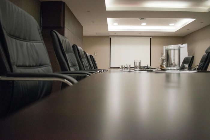 Joy Mastery Institute-Governance Council Deliberation-Closed-door boardroom setting for executive deliberation and collective decision-making