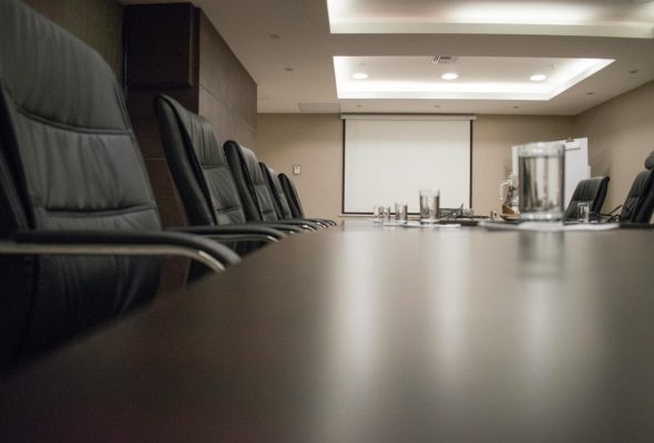 Closed-door boardroom setting for executive deliberation and collective decision-making